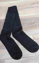 Pair of black socks on a wooden floor
